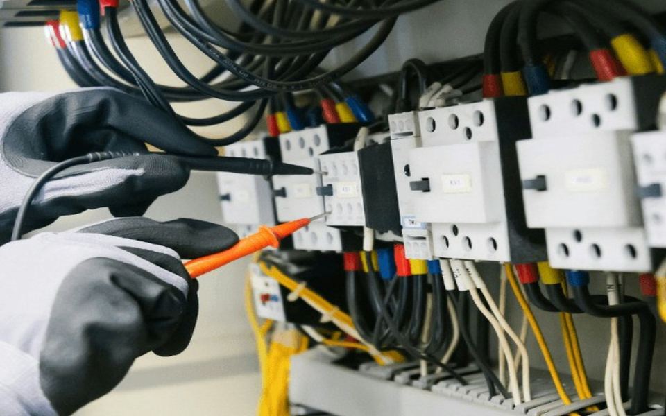 Electrician testing a home breaker panel