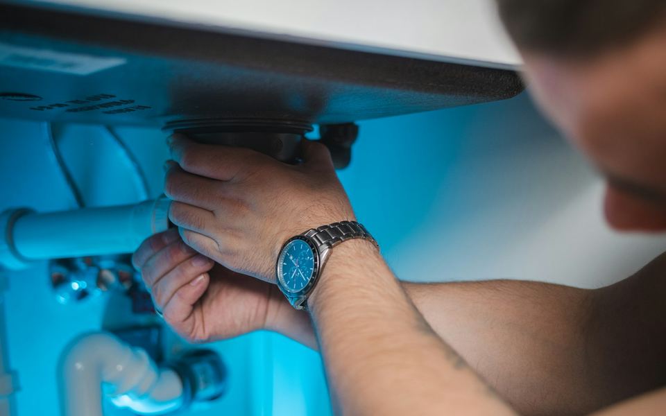 Plumber repairing a residential water heater